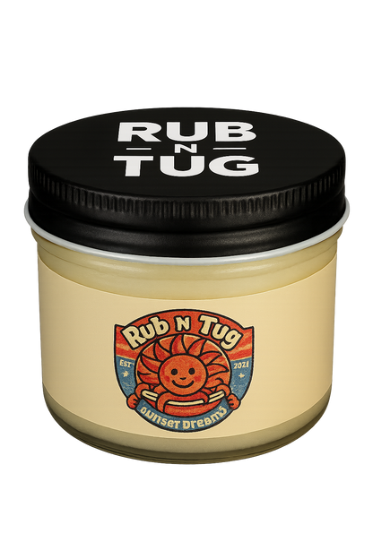A clear glass jar of Rub N Tug pomade labeled “Sunset Dreams,” topped with a black screw-on lid featuring bold white “RUB N TUG” lettering. The label showcases a cheerful, cartoon-style sun with barber pole arms in red, white, and blue tones, evoking a vintage Americana vibe.  Natural men’s hair pomade, veteran-owned, 4th generation barber-approved, all-natural ingredients, strong hold, classic finish, Rub N Tug grooming products USA.
